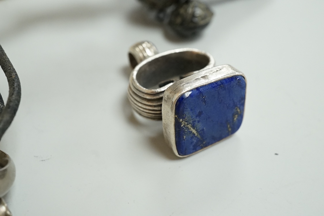 A George V silver circular vesta case, S. Blanckensee & Son Ltd, Birmingham, 43mm, together with a damaged silver child's rattle by George Unite, a cat child's rattle, white metal and lapis lazuli set fob, etc.